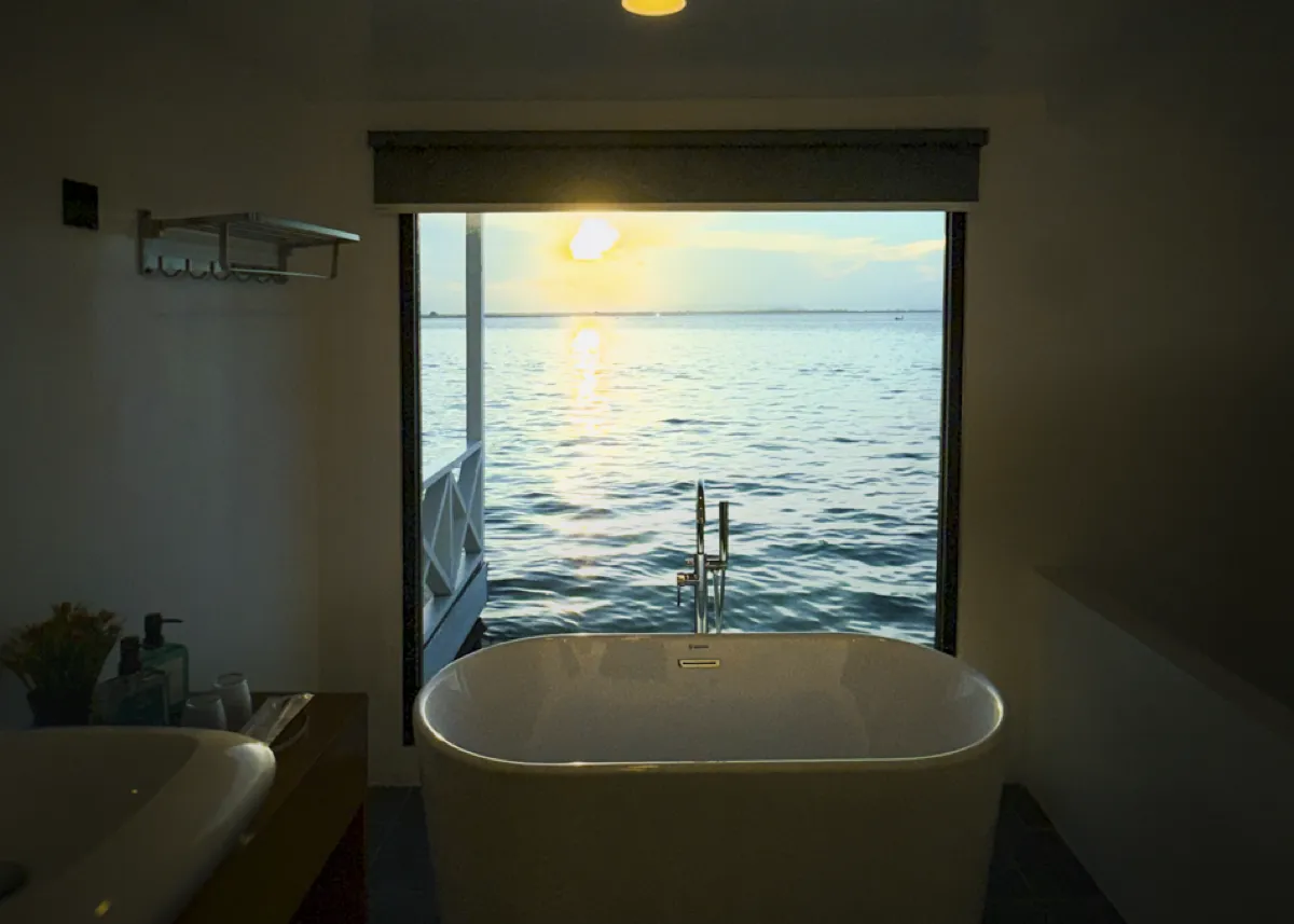 Double storey bathtub with sunset sea view